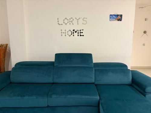 a blue couch sitting in a living room at Bari Lory’s Home in Bari