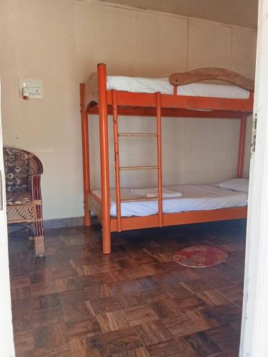 two bunk beds in a room with a wooden floor at Cabana Coral Reef in Mandapam