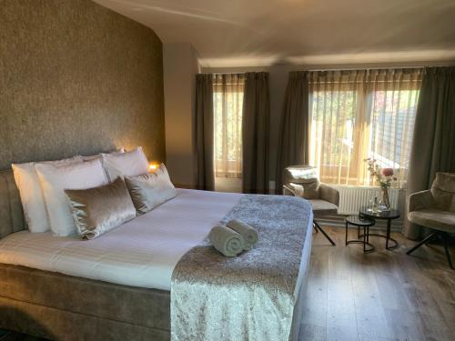 a hotel room with a large bed and a chair at De La Frontière Bed & Borrelbistro in Slenaken