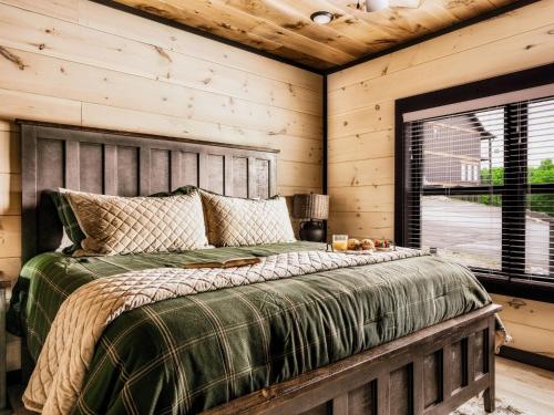 a bedroom with a bed with a wooden wall at Smith Creek Resort - Exclusive Waterpark Included in Sevierville