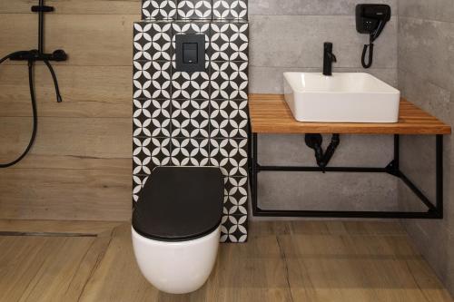a bathroom with a toilet and a sink at Maria village resort in Pavel Banya