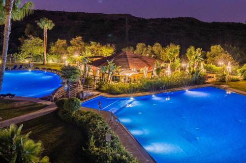 an overhead view of a pool at night at Parque Botanico Resort Country club in Estepona