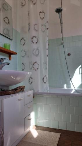 a white bathroom with a shower and a sink at La terrazza sul Lago Maggiore in Brezzo