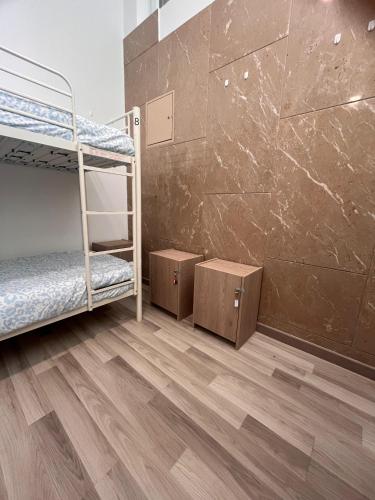 a room with bunk beds and a wooden floor at The Vault in Portimão