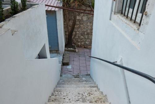 a stairway leading up to a building with a door at Aura Maris Apartment in Kotor