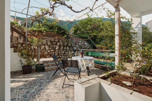 a table and chairs sitting on a patio at Aura Maris Apartment in Kotor