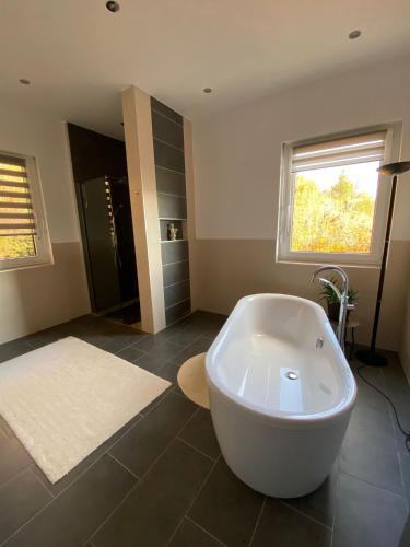a large bathroom with a tub and a sink at Spa-Villa mit privatem Whirlpool&Sauna und Panoramablick in Wellheim