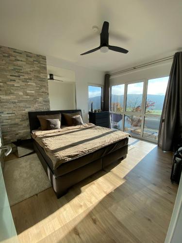 a bedroom with a bed and a ceiling fan at Spa-Villa mit privatem Whirlpool&Sauna und Panoramablick in Wellheim