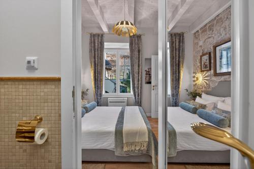 a hotel room with a bed and a window at Dominus Little Palace in Dubrovnik