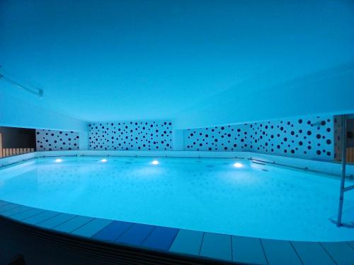 a large swimming pool in a building at Logis Hôtel Le Rochelois in La Rochelle