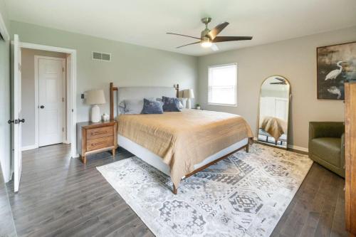 a bedroom with a bed and a ceiling fan at Spacious 4 BR 3 BA with Fenced Yard in Shawnee
