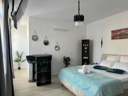 a bedroom with a bed and a chair in it at Uniri Urban Escape in Craiova