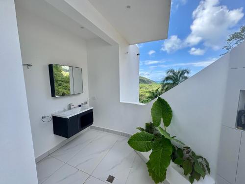 a bathroom with a sink and a window at Villa Blanca only accessible by 4x4 vehicle in El Valle