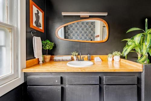 a bathroom with a sink and a mirror at 2 Fun Homes in Hudson