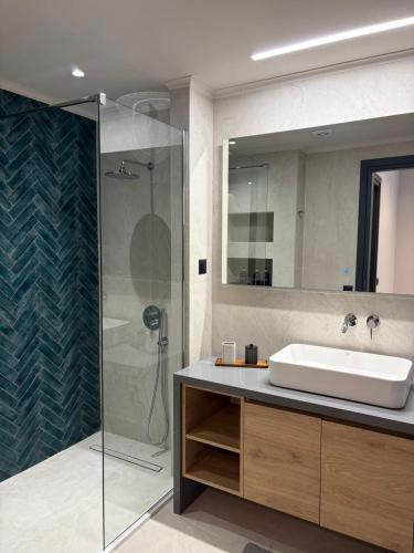 a bathroom with a sink and a shower at Elea Living Chios in Chios