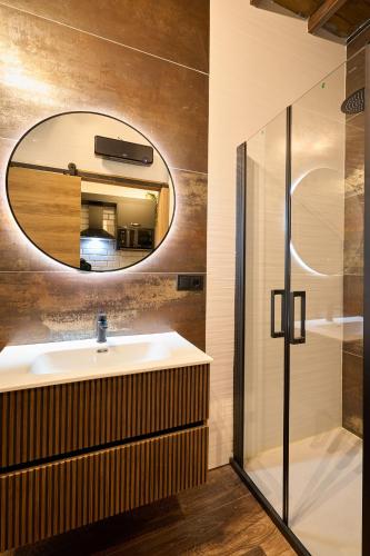 a bathroom with a sink and a mirror at Los Balcones de San Juan in Salamanca
