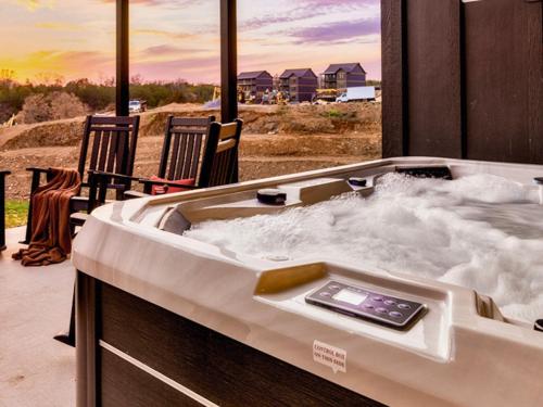 a hot tub with snow in it with two chairs at Smith Creek Resort - Exclusive Waterpark Included in Sevierville
