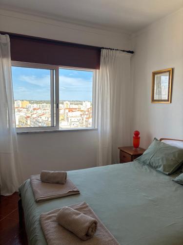 a bedroom with a bed with two towels on it at T2 A 150 m de la plage in Armação de Pêra