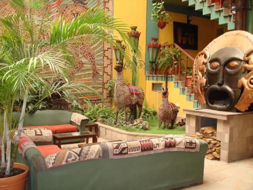 a living room with a couch and a mask at Nodo Cusco Santa Teresa in Cusco