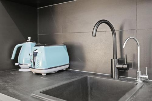 a kitchen counter with a mixer and a sink at South Beach Studio - Simple Base, Walk Everywhere in South Fremantle