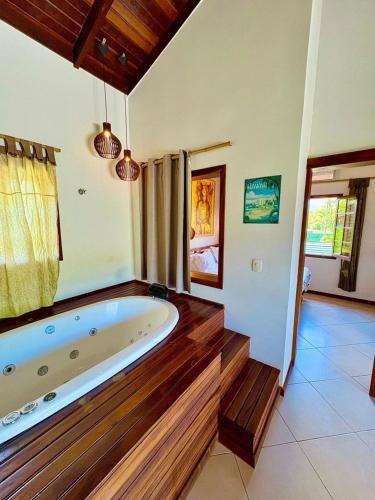 a large bathroom with a large tub in a room at Residencial Villa Cris - Jd. São Lourenço/Itaguaré in Bertioga