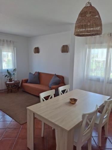 a living room with a table and a couch at Casa R in Sesimbra
