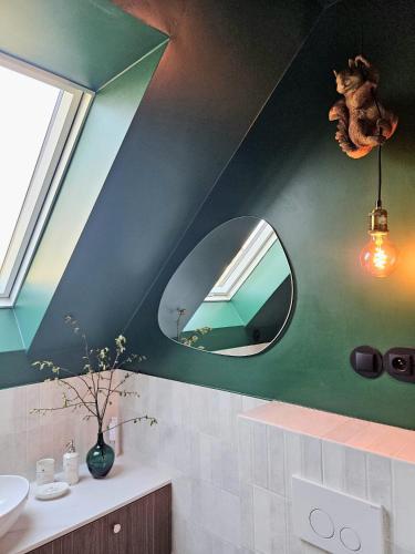 a bathroom with a mirror and a sink at Apartamenty Klikuszówka in Nowy Targ