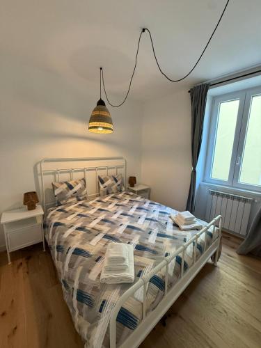 a bedroom with a bed with a comforter at 11 Apartaclean Cancellieri in Trieste