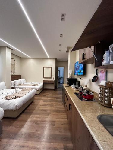 a kitchen with two beds and a living room at nova pyramids inn in Cairo