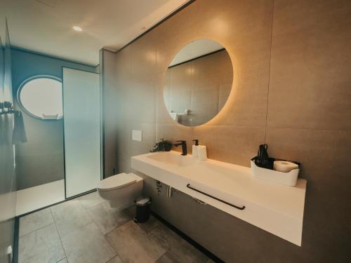 a bathroom with a sink and a mirror at Bungalows da Travanca in Arcos de Valdevez