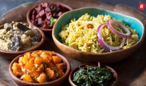 a group of bowls of food on a table at YMCA Hotel in London