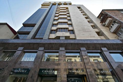 a tall building with the words canada on it at Elite & Grand Luxury Hotel Apartments in Central Yerevan, By Opera and Northern Avenue in Yerevan