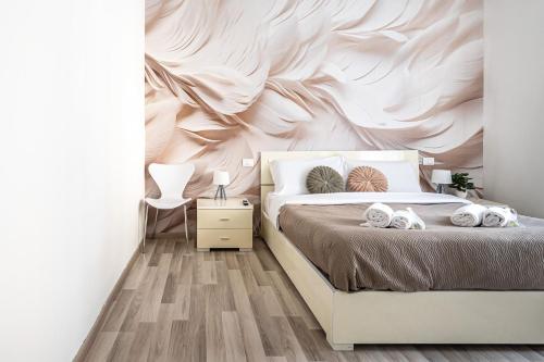 a bedroom with a bed with a wall mural at Da Vinci Suite Modern Rooms near Metro Basilica San Paolo in Rome