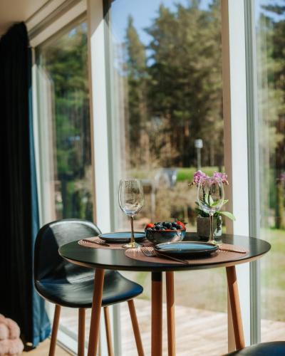 a table with two chairs and a wine glass at Üleoja Pesa in Kloogaranna