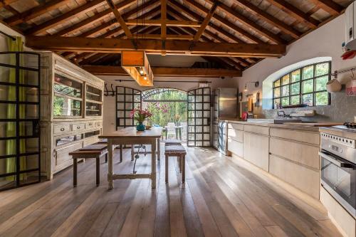 a large kitchen with a wooden table and chairs at Holiday House La Teja in Facinas