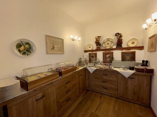 a kitchen with a bath tub and wooden cabinets at Hotel Landhaus Sternen in Sipplingen