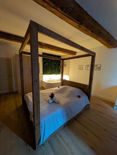 a large bed in a room with a window at Suite avec jacuzzi privatif in Vergèze