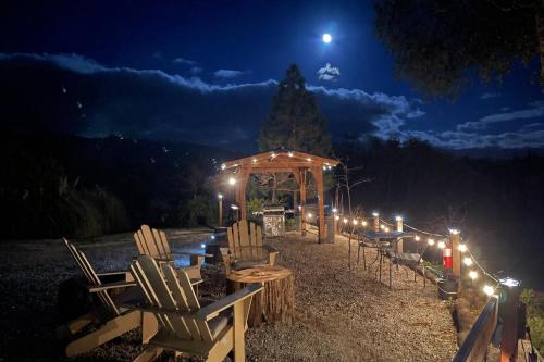 a group of chairs and a gazebo at night at Sierra Mountain Lodge - Vacation Rentals - Yosemite in Ahwahnee
