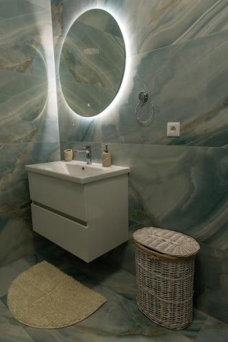 a bathroom with a sink and a mirror at Apartment LANA in Čapljina