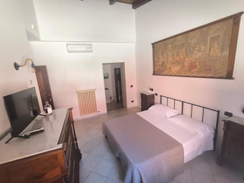 a bedroom with a bed and a flat screen tv at Residenza Borgo Francescano in Gioia del Colle