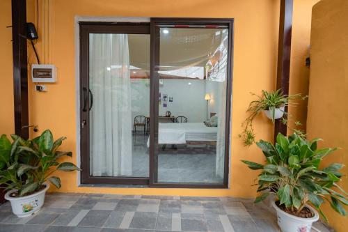 a sliding glass door with a bedroom in the background at Dreamy Homestay in Xuân Sơn