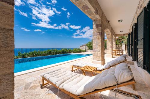 a villa with a swimming pool and a patio at Villa Azzurra in Krstac