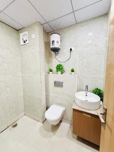 a bathroom with a toilet and a sink at Gr Noida Stay & BNB in Greater Noida
