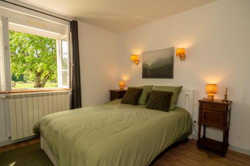 a bedroom with a large bed and a window at Domaine du Riadoux in Bonneuil