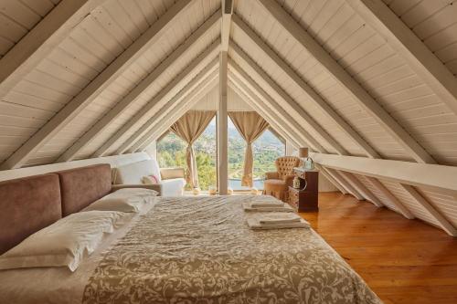 a bedroom with a large bed with a large window at Miragem do Douro in Marco de Canaveses