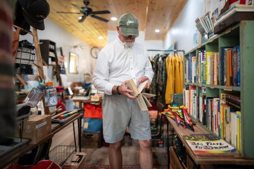 a man is standing in a book store at The Speckled Trout Outpost in Damascus