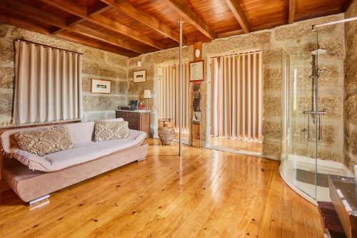 a living room with a couch and a tub at Miragem do Douro in Marco de Canaveses