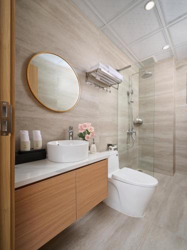 a bathroom with a sink and a toilet and a mirror at Solla Hotel in Ninh Binh