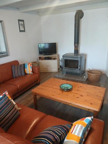 a living room with a couch and a wood stove at gite du canal in Ormoy