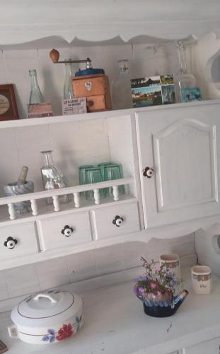 a white cabinet with a toilet in a room at gite du canal in Ormoy
